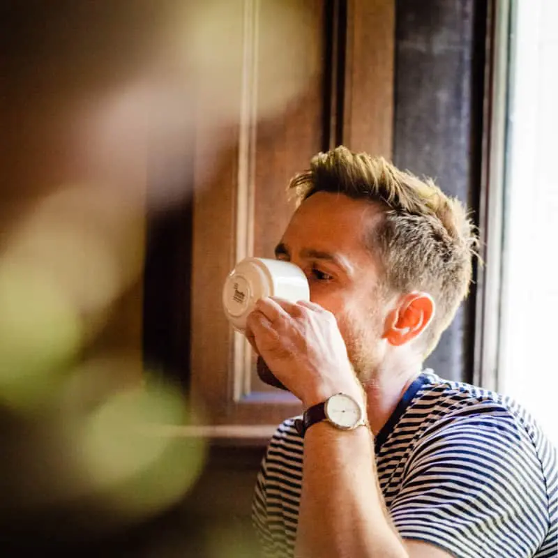 Photo of Antony Moss drinking a cup of tea